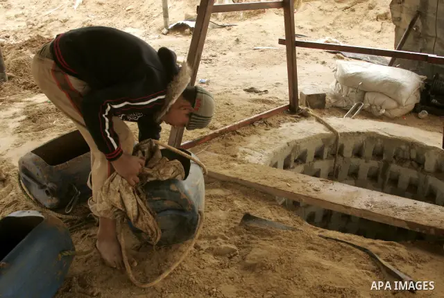 Palestinians work in a smuggled tunnel on the border between Egypt and Gaza in Rafah, southern Gaza Strip on January, 30, 2011. at least two of the prisoners who had been held in Abu Zaabal prison, northeast of Cairo, ha...