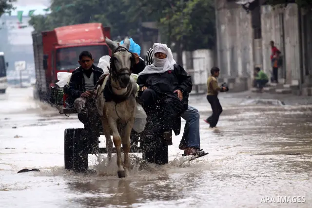 Palestinians ride their cart in a rain flooded street in Gaza City, Tuesday, Feb. 1 , 2011.. Photo by Mohammed Asad