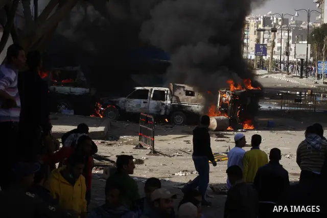 Police vehicles are set on fire by anti-government demonstrators in Cairo, capital of Egypt, on Friday, Jan. 28, 2011. Photo by Karam Nasser