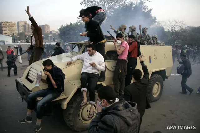 Egyptian Army soldiers riding in an armored personnel carrier is surrounded by anti-government protesters near Tahrir square in Cairo, Egypt, Friday, Jan. 28, 2011. Photo by Karam Nasser