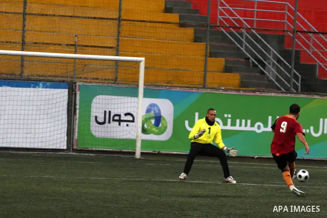 Palestinians play a football match between Tulkarem Cultural club and Balata Camp club in the occupied West Bank on Feb. 1,2011. Photo by Issam Rimawi