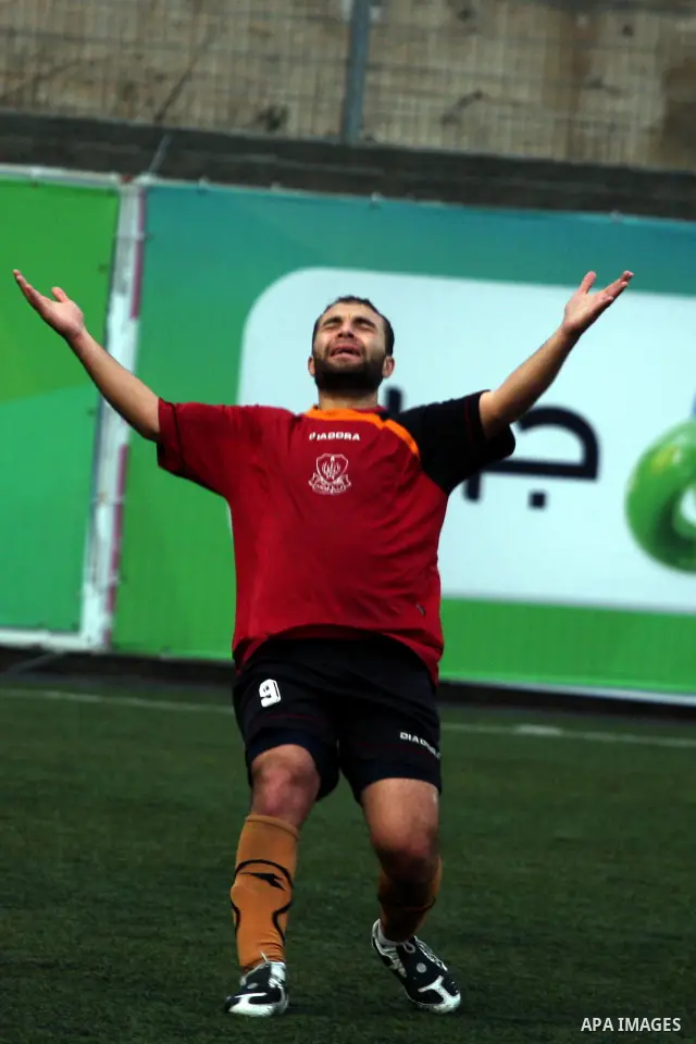 Palestinians play a football match between Tulkarem Cultural club and Balata Camp club in the occupied West Bank on Feb. 1,2011. Photo by Issam Rimawi