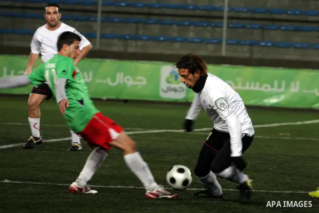 Palestinians play a football match between Mukaber Mountain club and Amari camp club in the occupied West Bank on Feb. 1,2011. Photo by Issam Rimawi