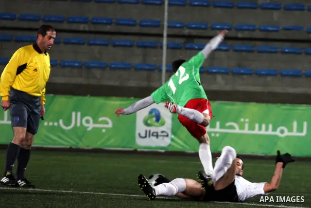 Palestinians play a football match between Mukaber Mountain club and Amari camp club in the occupied West Bank on Feb. 1,2011. Photo by Issam Rimawi