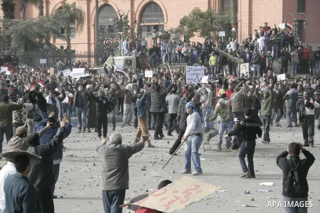 Protestors from the pro-Mubarak camp throw stones and push back the anti-Mubarak protestors on a street leading into Tahrir Square in central Cairo, Egypt on 02 February 2011. Several thousands pro-Mubarak supporters mar...
