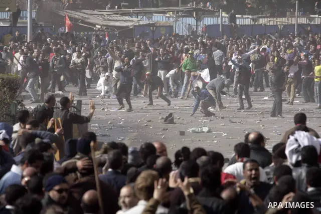 Protestors from the pro-Mubarak camp throw stones and push back the anti-Mubarak protestors on a street leading into Tahrir Square in central Cairo, Egypt on 02 February 2011. Several thousands pro-Mubarak supporters mar...