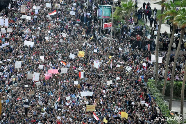 Anti-government demonstrators march in Alexandria, Egypt, Tuesday, Feb.1, 2011. Egyptian President Hosni Mubarak defied a quarter-million protesters demanding he step down immediately, announcing he would serve out the l...