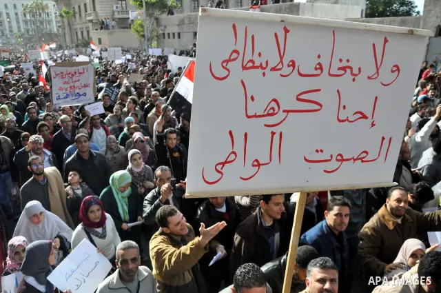 Anti-government demonstrators march in Alexandria, Egypt, Tuesday, Feb.1, 2011. Egyptian President Hosni Mubarak defied a quarter-million protesters demanding he step down immediately, announcing he would serve out the l...