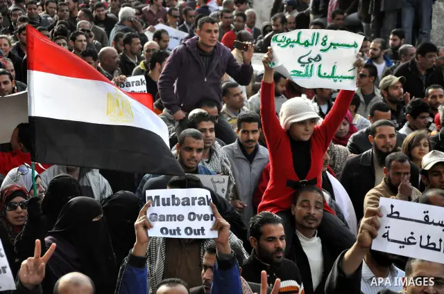 Anti-government demonstrators march in Alexandria, Egypt, Tuesday, Feb.1, 2011. Egyptian President Hosni Mubarak defied a quarter-million protesters demanding he step down immediately, announcing he would serve out the l...
