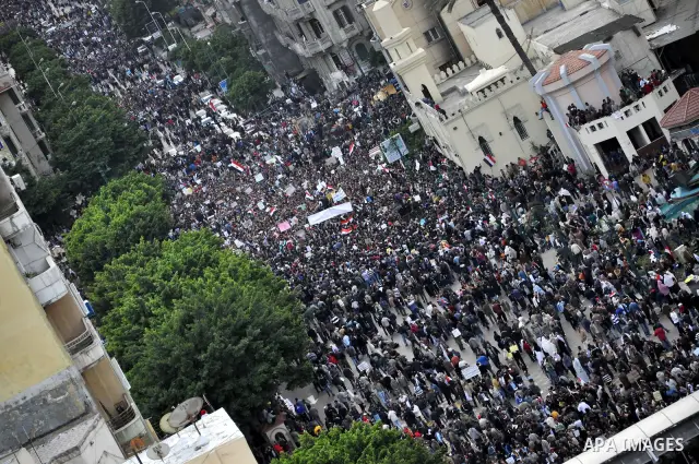 Anti-government demonstrators march in Alexandria, Egypt, Tuesday, Feb.1, 2011. Egyptian President Hosni Mubarak defied a quarter-million protesters demanding he step down immediately, announcing he would serve out the l...