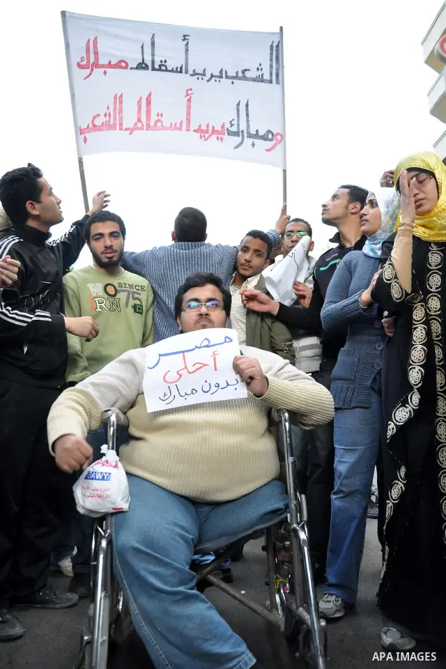 Anti-government demonstrators march in Alexandria, Egypt, Tuesday, Feb.1, 2011. Egyptian President Hosni Mubarak defied a quarter-million protesters demanding he step down immediately, announcing he would serve out the l...