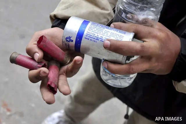An Egyptian protestor holds a tear gas made in U.S.A " as shown ", during a march in Alexandria, Egypt, Jan. 28, 2011. Egyptian President Hosni Mubarak defied a quarter-million protesters demanding he step down immediate...