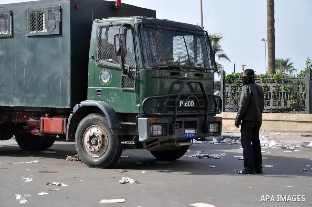 An Egyptian protester stand in front of Egyptian police during fresh demonstrations that erupted following Friday prayers in Alexandria, Egypt, Jan. 28, 2011. Violent clashes marked a 'Friday of rage' in Egypt, as anti-g...