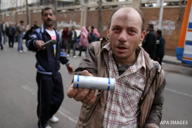 An Egyptian protestor holds a tear gas made in U.S.A " as shown ", during a march in Alexandria, Egypt, Jan. 28, 2011. Egyptian President Hosni Mubarak defied a quarter-million protesters demanding he step down immediate...