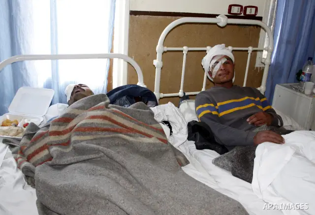 A wounded protester is being treated after being injured during clashes in Cairo's main square, Egypt, Thursday, Feb. 3, 2011. Egyptian army tanks and soldiers moved to end violence between anti-government protesters and...