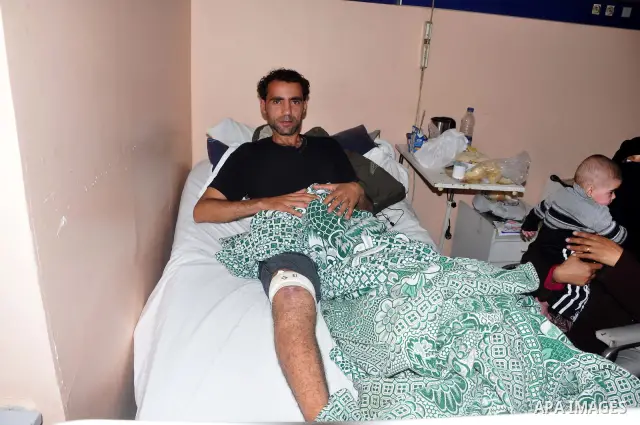 A wounded protester is being treated after being injured during clashes in Cairo's main square, Egypt, Thursday, Feb. 3, 2011. Egyptian army tanks and soldiers moved to end violence between anti-government protesters and...