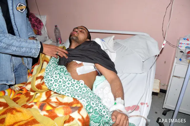 A wounded protester is being treated after being injured during clashes in Cairo's main square, Egypt, Thursday, Feb. 3, 2011. Egyptian army tanks and soldiers moved to end violence between anti-government protesters and...