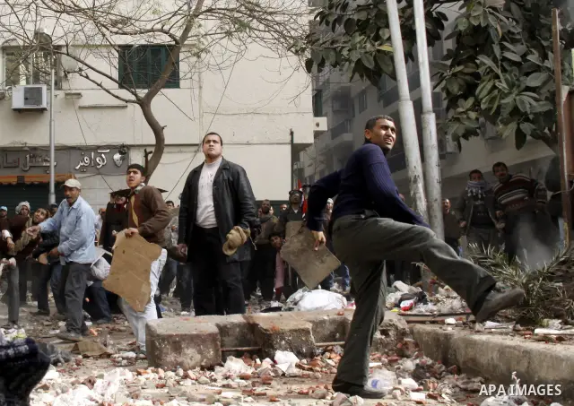 Egyptian pro government protesters throw stones at anti government protesters in downtown Cairo, Egypt, Thursday, Feb. 3, 2011. New clashes are heating up again and shots are being fired in the air around Cairo's central...