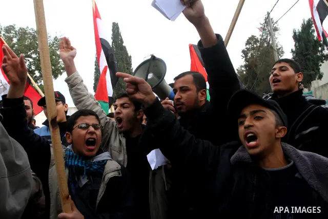Palestinian protesters wave Egyptian flags and shout slogans during a demonstration outside the offices of the Egyptian diplomatic mission in Gaza City on February 3, 2011 in support of the anti-government protests in Eg...