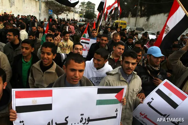 Palestinian protesters wave Egyptian flags and shout slogans during a demonstration outside the offices of the Egyptian diplomatic mission in Gaza City on February 3, 2011 in support of the anti-government protests in Eg...