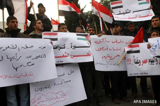Palestinian protesters wave Egyptian flags and shout slogans during a demonstration outside the offices of the Egyptian diplomatic mission in Gaza City on February 3, 2011 in support of the anti-government protests in Eg...