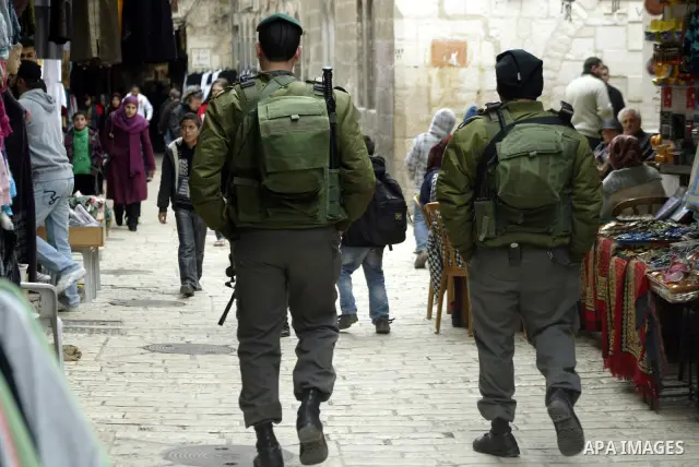 Israeli police officers walk in the market of the old city of Jerusalem on Feb. 3,2011. Photo by Mahfouz Abu Turk