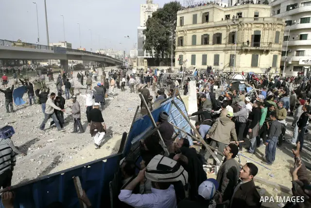 Egyptian protesters are seen in and around Tahrir square, as supporters and opponents of President Hosni Mubarak clash in some parts of the square, Cairo, capital of Egypt, Feb. 3, 2011. Egyptian army appeared to be tryi...