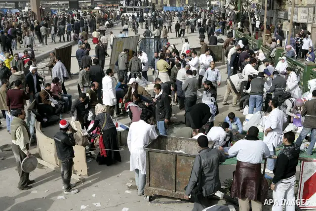 Egyptian protesters are seen in and around Tahrir square, as supporters and opponents of President Hosni Mubarak clash in some parts of the square, Cairo, capital of Egypt, Feb. 3, 2011. Egyptian army appeared to be tryi...