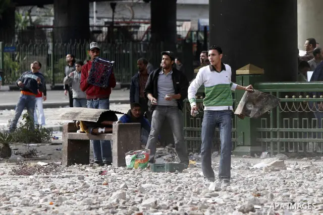 Egyptian protesters are seen in and around Tahrir square, as supporters and opponents of President Hosni Mubarak clash in some parts of the square, Cairo, capital of Egypt, Feb. 3, 2011. Egyptian army appeared to be tryi...