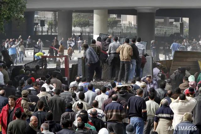 Egyptian protesters are seen in and around Tahrir square, as supporters and opponents of President Hosni Mubarak clash in some parts of the square, Cairo, capital of Egypt, Feb. 3, 2011. Egyptian army appeared to be tryi...
