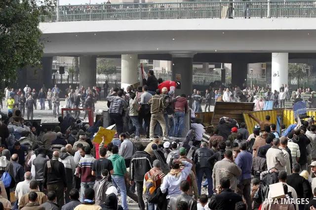 Egyptian protesters are seen in and around Tahrir square, as supporters and opponents of President Hosni Mubarak clash in some parts of the square, Cairo, capital of Egypt, Feb. 3, 2011. Egyptian army appeared to be tryi...
