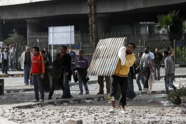 Egyptian protesters are seen in and around Tahrir square, as supporters and opponents of President Hosni Mubarak clash in some parts of the square, Cairo, capital of Egypt, Feb. 3, 2011. Egyptian army appeared to be tryi...
