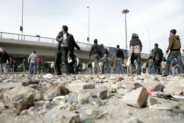 Egyptian protesters are seen in and around Tahrir square, as supporters and opponents of President Hosni Mubarak clash in some parts of the square, Cairo, capital of Egypt, Feb. 3, 2011. Egyptian army appeared to be tryi...