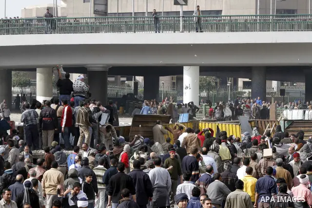 Egyptian protesters are seen in and around Tahrir square, as supporters and opponents of President Hosni Mubarak clash in some parts of the square, Cairo, capital of Egypt, Feb. 3, 2011. Egyptian army appeared to be tryi...