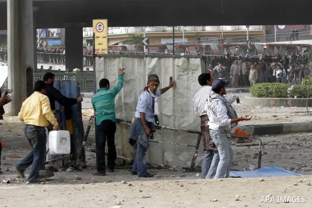 Egyptian protesters are seen in and around Tahrir square, as supporters and opponents of President Hosni Mubarak clash in some parts of the square, Cairo, capital of Egypt, Feb. 3, 2011. Egyptian army appeared to be tryi...