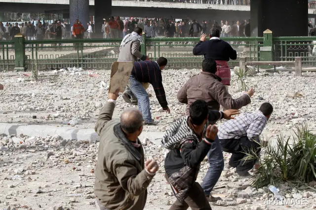 Egyptian protesters are seen in and around Tahrir square, as supporters and opponents of President Hosni Mubarak clash in some parts of the square, Cairo, capital of Egypt, Feb. 3, 2011. Egyptian army appeared to be tryi...