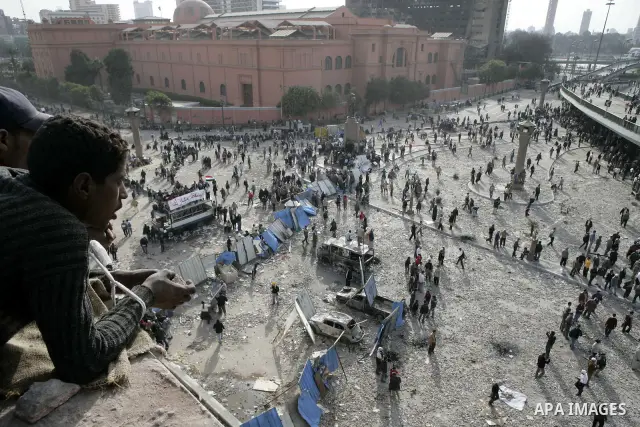 Egyptian protesters are seen in and around Tahrir square, as supporters and opponents of President Hosni Mubarak clash in some parts of the square, Cairo, capital of Egypt, Feb. 3, 2011. Egyptian army appeared to be tryi...
