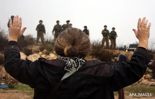 Israeli soldiers stand guard and fier tear gas during a protest against Israel's controversial separation barrier in the West Bank village of Wad Rahal,near the biblical town of Bethlehem, on February 04, 2011. Israel sa...