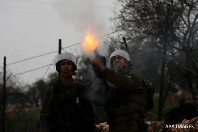 Israeli sildiers fire tear gas canisters towards Palestinian protesters during a protest in the village of Bilin on Feb. 4, 2011. Photo by Issam Rimawi