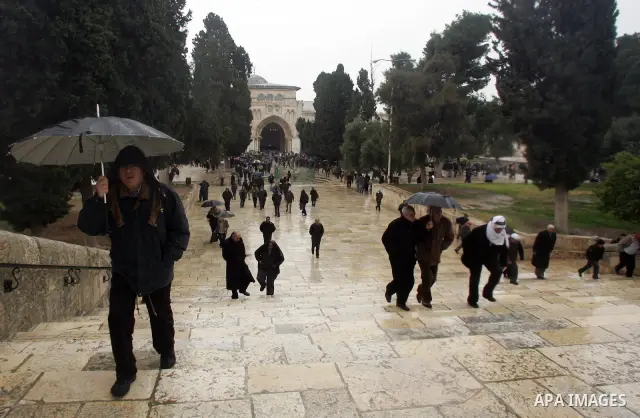 Palestinian Muslims walk in front of Alaqsa mosque after Fridays prayers in the old city of Jerusalem on Feb. 4,2011. Photo by Mahfouz Abu Turk