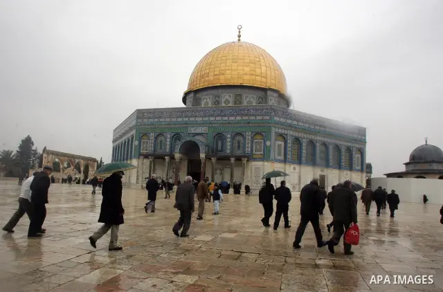Palestinian Muslims walk in front of the Dome of the Rock after Fridays prayers in the old city of Jerusalem on Feb. 4,2011. Photo by Mahfouz Abu Turk