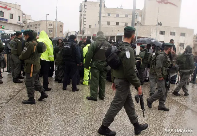 Israeli soldiers check Palestinian worrshippers aim to attend Friday prayers outside the Al Aqsa Mosque compound, also known to Jews as the Temple Mount, in Jerusalem's old city in the old city of Jerusalem on Feb. 4,201...
