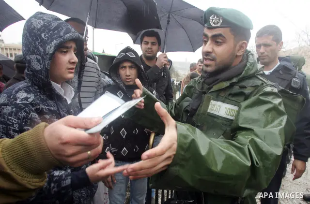 Israeli soldiers check Palestinian worrshippers aim to attend Friday prayers outside the Al Aqsa Mosque compound, also known to Jews as the Temple Mount, in Jerusalem's old city in the old city of Jerusalem on Feb. 4,201...