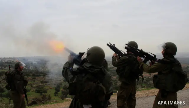 Israeli sildiers fire tear gas canisters towards Palestinian protesters during a protest in the village of Bilin near Ramallah on Feb. 4, 2011. Photo by Wagdi Eshtayah