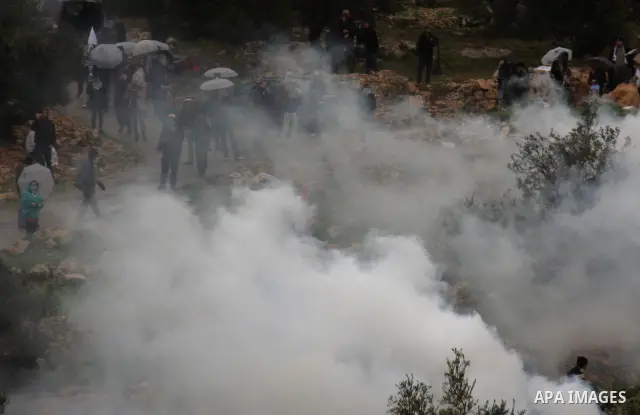 Israeli sildiers fire tear gas canisters towards Palestinian protesters during a protest in the village of Bilin near Ramallah on Feb. 4, 2011. Photo by Wagdi Eshtayah