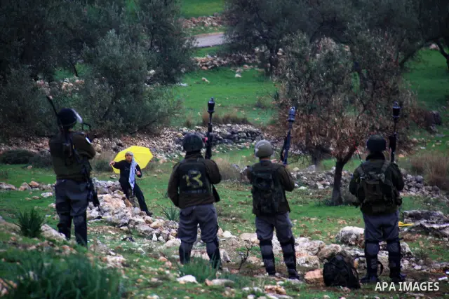 Israeli soldiers stand guards during a protest against Israel's separation barrier in the West Bank village of Bilin near Ramallah, Friday, Feb 4, 2011. Photo by Wagdi Eshtayah