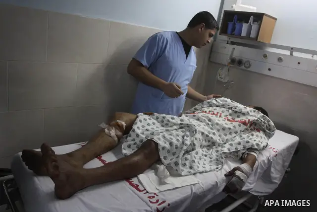 A wounded Palestinian man receives treatment at Al-Shifa hospital in Gaza City, Feb. 5, 2011. A three Palestinian were wounded Saturday when Israeli troops opened fire on Palestinian workers who collect stones in eastern...