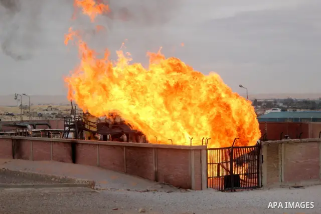 Flames are seen after an explosion went off at a gas terminal in Egypt's northern Sinai Peninsula on Saturday, Feb. 5, 2011 in El-Arish, setting off a massive fire. No injuries were reported, and the blaze was quickly br...