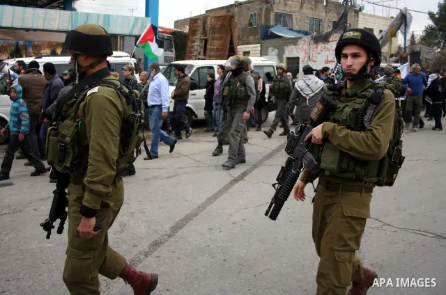 Israeli soldiers take position during during a demonstration against the Israeli controversial separation barrier in the West Bank village of Beit Omar, near Hebron, 05 February 2011. Israel says the network of steel and...