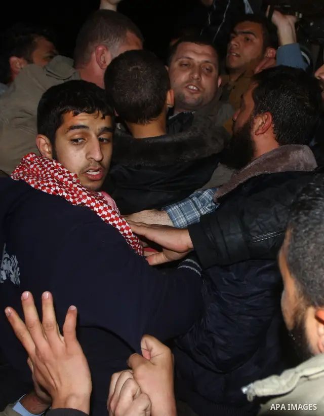 Ayman Nofal , a top Hamas armed commander, is greeted by Hamas supporters upon his arrival to his home in Nusairat in the Central Gaza strip February 5, 2011. A senior Hamas commander returned to the Gaza Strip on Saturd...